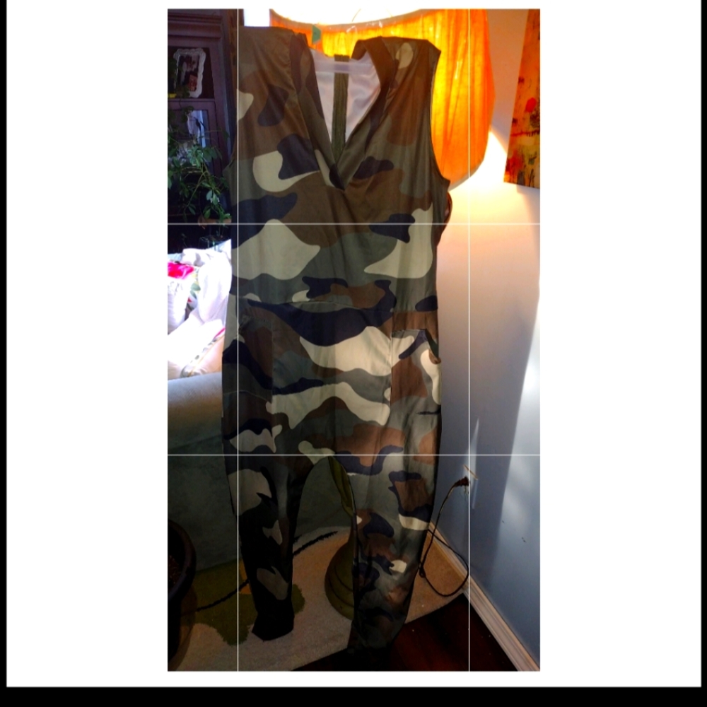 A camouflage jumpsuit with a zipper down the back v-neck in the size med